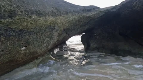 Ocean Waves Washing Through Natural Coastal Rock Arch Stock Footage 340414150
