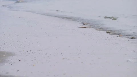 Ocean waves on the wet beach sand after sunrise. Stock Footage 73608514