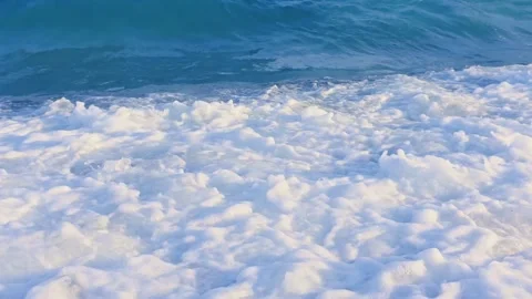 Ocean waves with white foam and spray crashing on a Mediterranean beach, dy.. Stock Footage 337796015