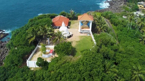 Oceanfront hillside temple with jungle backdrop Stock Footage 273018295