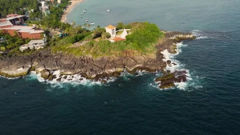 Oceanfront hillside temple with jungle backdrop Stock Footage 273018298