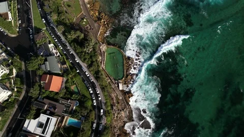 Oceanfront property + Bronte Baths with waves crashing against rocks from above. Stock Footage 168914602