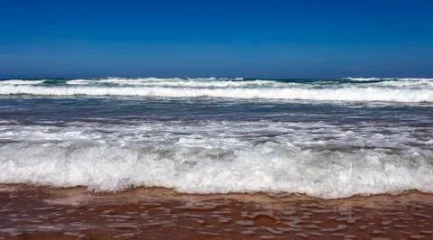Oceanic long wave on a sandy beach . Stock Photos
