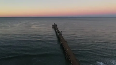 Oceanside Surfers at dawn, drone shot, Oceanside pier, sunrise, ocean, Stock Footage 201764520
