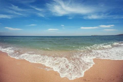 Oceanside under blue sky with clouds Stock Photos