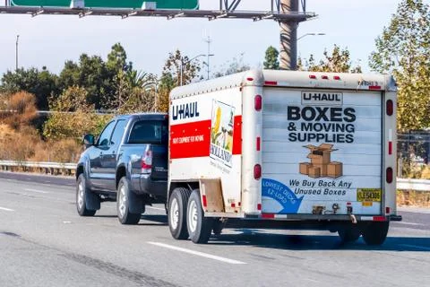Oct 26, 2019 Mountain View / CA / USA - Semi truck towing an U-Haul cargo tra Stock Photos