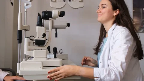 Oculist is checking patient's eye sight Stock Footage 119611081