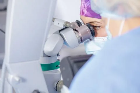 Oculoplastic surgeon using surgical microscope during upper eyelid blepharo.. Stock Photos