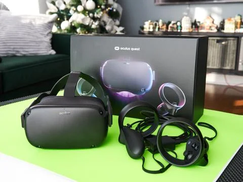 Oculus Quest VR virtual reality headset and controllers on a green table Stock Photos