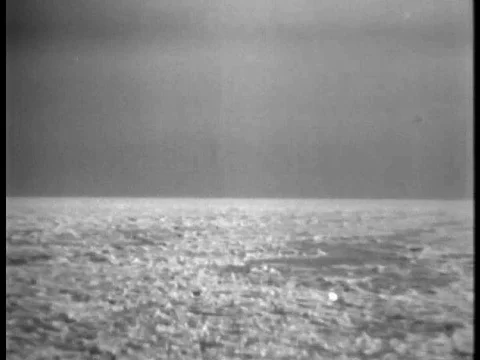 Odd 1930s scene of people in bathing suits horsing around and jumping into a Stock Footage