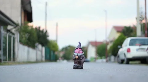 Odd dwarf statue miniature in the middle of the street Stock Footage 47323829