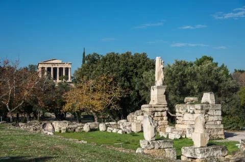 Odeon of Agrippa statues with Temple of Hephaestus at background. Ancient Ago Stock Photos