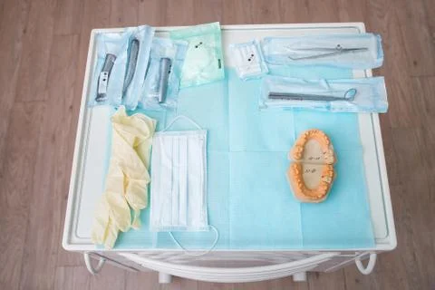 Odontological tooth model and instruments at dentist manipulation table Stock Photos