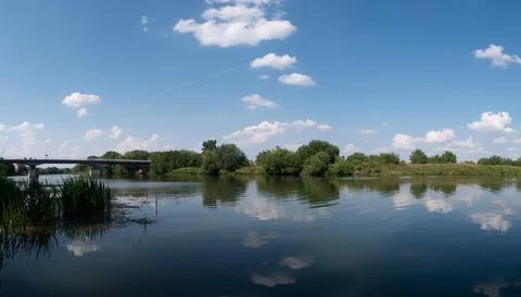 Odra river with bridge in background during summer Фото