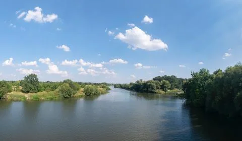 Odra river in summer with slightly cloudy sky and greenery Foto stock