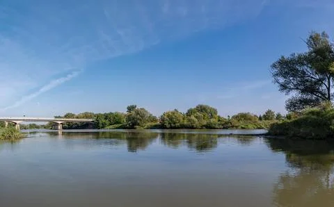Odra river in summer with slightly cloudy sky and greenery Foto stock