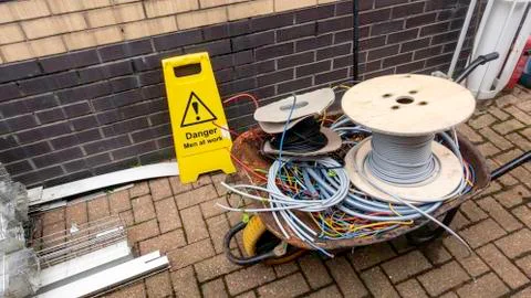 Offcuts of scrap electrical cable in a wheelbarrow Stock Photos