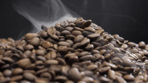 Offee beans rotate while roasting. Smoke comes from coffee beans. Stock Footage 119065976