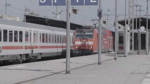 Offenburg, Germany - 05/08/2022: Red Deutsche Bahn train arriving at a Stock Footage 270105029