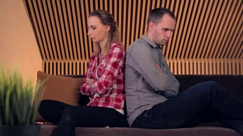 Offended, angry couple sitting on sofa at home Stock Footage 72480429