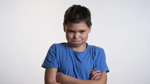 Offended boy folding hands on white background Видео 241517263