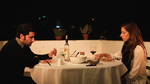 Offended couple sitting by table in a restaurant outside Stock Footage 88987220