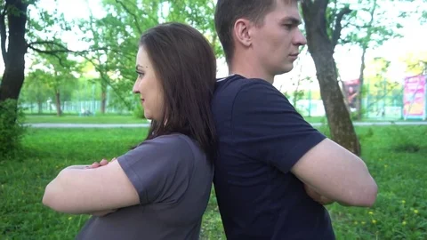 The offended couple standing back each other in the Park Stock Footage 75444437