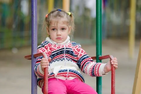 Offended by the girl on swing does not want to go home Stock-Fotos