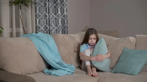 Offended kid sitting on couch. Upset unhappy cute girl feeling sad.  Stock Footage 264119011