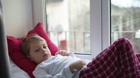 Offended little boy looking through the window Stock Footage 91171071