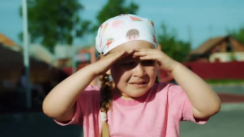 An offended little girl is crying in front of a playground. Stock Footage 335814799