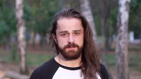 Offended man looking at camera being exhausted in the forest. Stock Footage 120512823