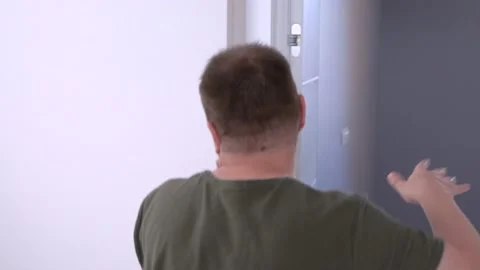 Offended young man theatrically runs away to another room in tears, covering Stock Footage 132876019