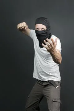 An offender attack with Brass knuckles. Metal brass knuckles in the hand of c Stock Photos