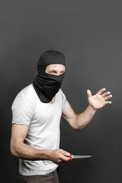 An offender attack with a knife. Metal knife in the hand of caucasian man in  Stock Photos