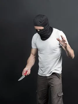 An offender attack with a knife. Metal knife in the hand of caucasian man in  Stock Photos