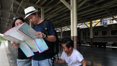 The offender steals a bag from a asian man tourist look at map Stock Footage 93019136
