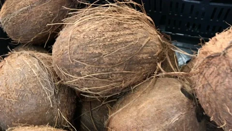 Offer coconuts in the store. Sweet pleasure hidden under a hard shell. Stock Footage 133166078