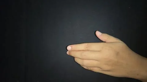 Offering a hand in a gesture inviting a handshake. Isolated on black backgrou 写真素材