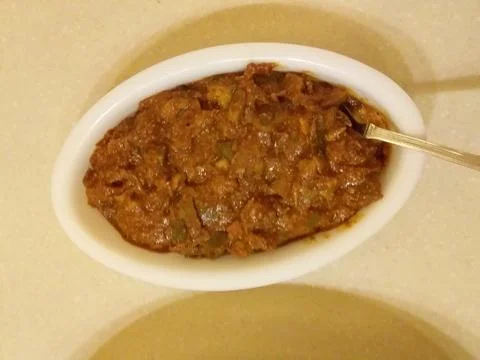 Offering mango pickle in a party Stock Photos