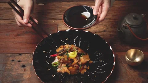 Offering Plated Side Dish Forward with Chopsticks Stock Footage 334832869