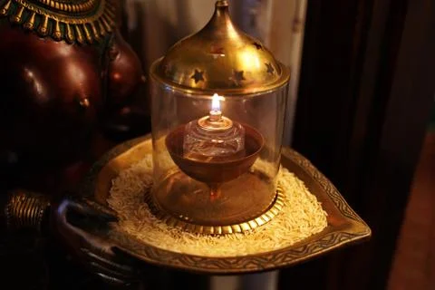 Offering of rice and a lit lamp on a deity is just some of the rituals of Hin Stock Photos