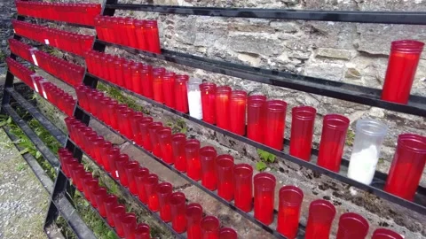 Offerings in the form of a red candle with lighted lights at the door of the Stock Footage 158957957