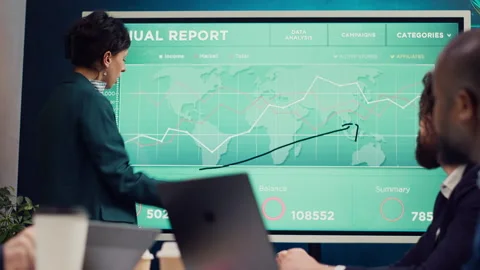 Office administrator presenting data reports and funding on interactive board Stock Footage 271604037