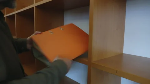 Office Administrator Removes last binder document nfolders from Empty Shelves Stock Footage 339082319