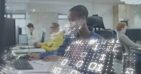 Office analyst taking notes, initiating binary overlay across desk for Video stock 318092911