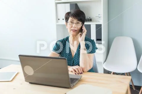 Office and business people concept - Middle aged woman at office working with Stock Photos