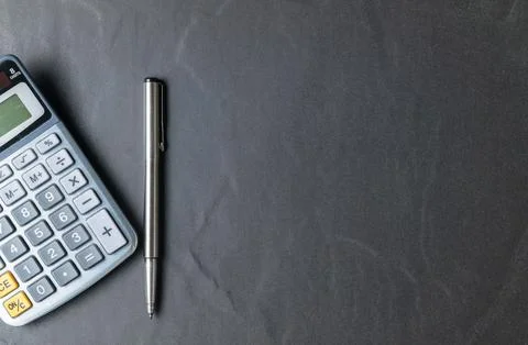 Office black stone desk table with calculator and pen 写真素材
