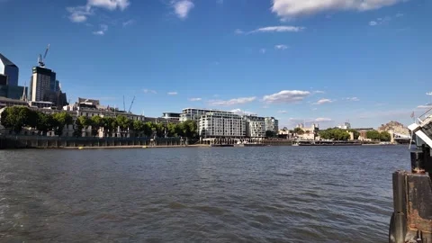 Office blocks and trees line the north bank as the camera pans westward over Stock Footage 341351582