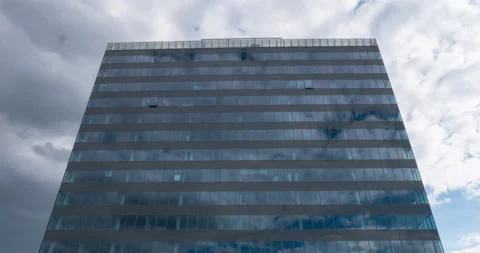 Office building with cloud reflection - Low angle timelapse video Stock Footage 231980541
